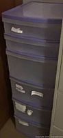 Front view of plastic storage tower showing five drawers and trim