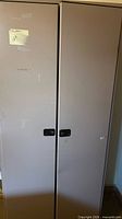 Front view of beige metal storage cabinet with two doors
