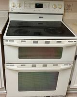 Front view showing cooktop, control panel, two oven doors