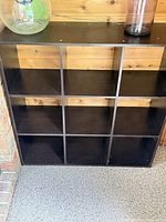 Front view of 9-cube dark brown storage shelf showing all compartments