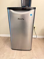 Front view of stainless steel Danby mini fridge closed