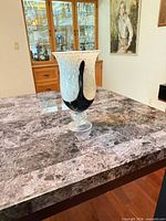 Front view of handblown speckled glass vase on table
