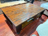 overall view of coffee table top, frame, casters and shelf