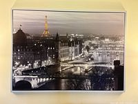 Full view of framed Paris cityscape print on wall