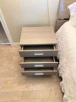 Nightstand front view with three drawers open