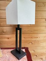 Full view of lamp showing black metal base and white shade