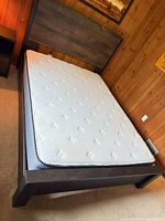 Full view of queen bed frame, headboard, and mattress