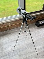 Full view of telescope on tripod with finder scope and eyepiece fitted