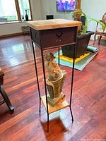 Full view of plant stand, wood top, metal frame, urn on lower shelf
