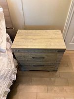 Top and front view of two-drawer nightstand showing finish and hardware