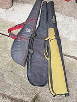 Three nylon shotgun cases laid out showing overall appearance and relative sizes