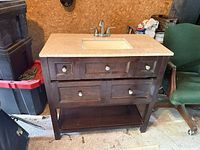Front view showing cabinet, drawers, shelf, countertop, sink, faucet