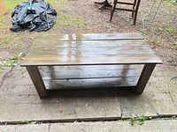 Top view of solid wood coffee table showing plank surface and lower shelf