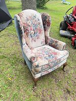 Front three-quarter view of chair showing upholstery pattern and cabriole legs