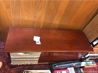 Top view of the closed wooden cedar chest showing polished dark brown finish and size perspective.