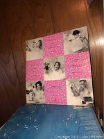 Front view of a vinyl album cover with a grid of photos showing people with playful or humorous makeup or expressions interspersed with bright pink sparkly squares.