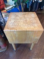 Angled view showing overall butcher block table with legs