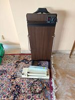 Front view of trouser press and Foodsaver sealer on floor