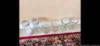 all six vases lined up: two cylindrical, two rounded, two flared hexagonal