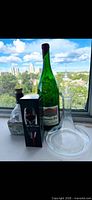 Lot overview with Vinturi box, green wine bottle, concrete base, glass decanter