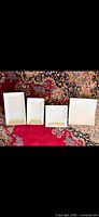 Four white porcelain serving platters/dishes arranged on rug showing shapes and condition