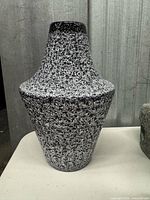 Front view of black-white lava textured ceramic vase