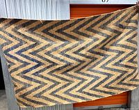 Full view of SAFAVIEH chevron rug held up, showing overall pattern and coloration