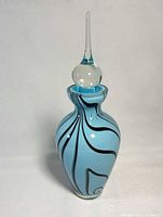 Front view of light blue art glass perfume bottle with stopper inserted