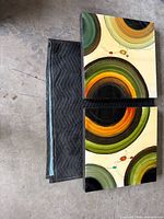 Front view of both lacquered art panels showing abstract design