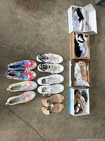All eight pairs displayed—two men’s Adidas, two tie-dye slip-ons, nude wedges, and three boxed women’s pairs