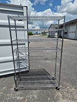 Front view of chrome six-shelf bakers rack on casters