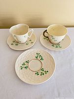 Front view showing both cups on saucers and extra plate