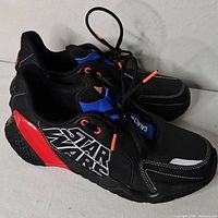 Side view showing Star Wars graphic and red heel panel on left shoe