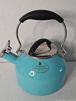 Front view of turquoise Chantal whistling kettle