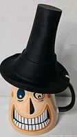 Smiling face side of Mayor mug showing hat lid and handle