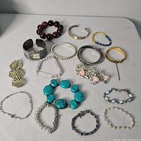 All sixteen bracelets laid out for full view