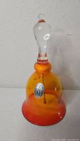 Front view of amberina bell showing Pilgrim Glass sticker and color gradient