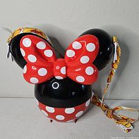 Front view showing bow, polka-dot base and strap