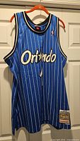 Full front view of blue Orlando Magic #1 jersey on hanger