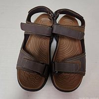 Top view of pair of brown Nunn Bush sandals showing footbeds and straps