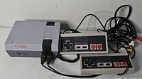 console with two controllers and A/V cable