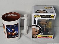 Funko Pop #315 Jannah box beside Star Wars Return of the Jedi mug