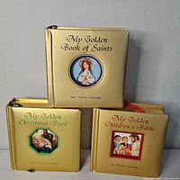 Front view of three gold hardcover books by Rev. Thomas J. Donaghy