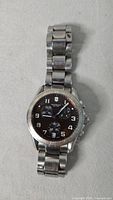 Front view showing dial, bezel, and bracelet