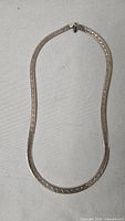 Full view of flat sterling herringbone necklace