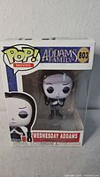 Front view of Funko Pop Movies Wednesday Addams #803 in sealed box