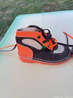 Right side view of left boot showing color pattern and lace-up