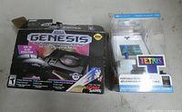 Front view of Sega Genesis Mini box and boxed Tetris micro arcade