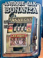 Front of retail box showing Antique Oak Bonanza Las Vegas slot machine coin bank image and features