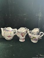Group shot of all three floral porcelain teapots